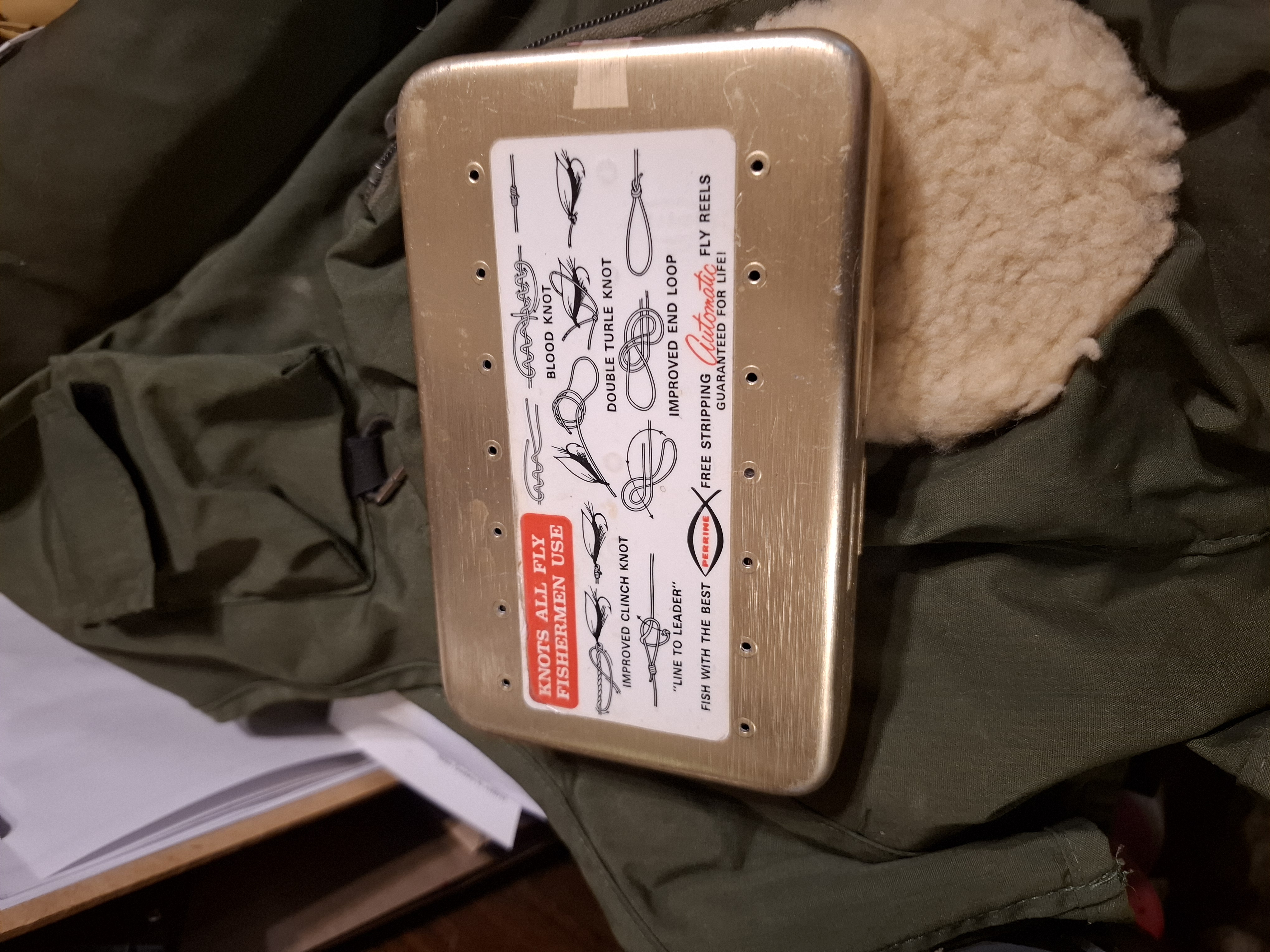 Vintage fly fishing box with flies and a xl fly fishing vest in an almost new condition